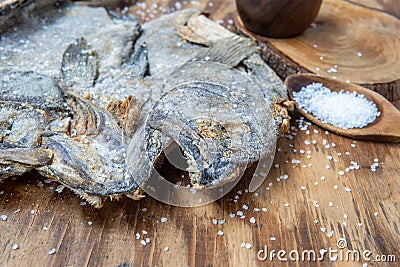 Dried and salted cod heads with skin and scales Stock Photo