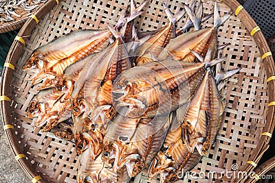 Dried salted fishes on brown basketry Stock Photo