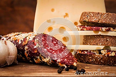 Dried sausage and cheese with holes for breakfast Stock Photo