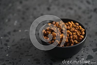 Dried seaberry buckthorn in black bowl on terrazzo countertop with copy space Stock Photo
