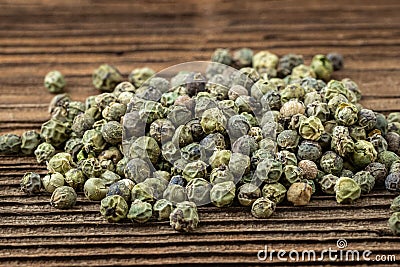 Dried spices green pepper on a wooden board Stock Photo