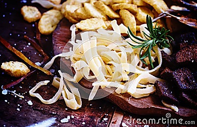 Dried squid, salted beer snacks. Junk food concept. Dark wood ba Stock Photo