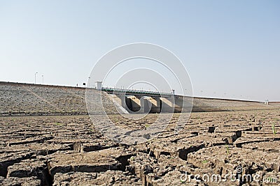 A dried up empty reservoir or dam during a summer heatwave, low rainfall and drought in north karnataka,India Stock Photo