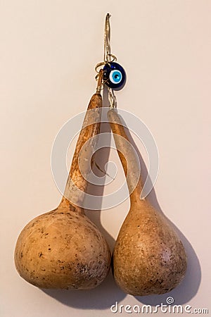 Dried zucchini and evil eye talisman Stock Photo