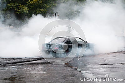 Drift car wheel drifting on the track with smoking tires. scraping the asphalt while racing Editorial Stock Photo