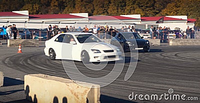 A drift racing car in action with smoking tires in show Editorial Stock Photo