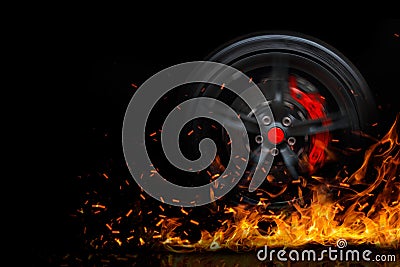 Drifting car wheel with smoke and fire isolated on a black background Stock Photo