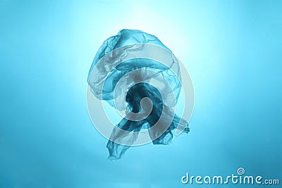 Drifting plastic bag in the form of a jellyfish in the world ocean. Concept of technogenic pollution of the planet Stock Photo