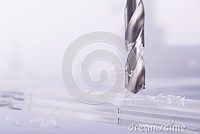 Drill bit make holes in opacity plastic, glass billet Stock Photo