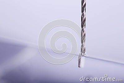 Drill bit make holes in opacity plastic, glass billet Stock Photo