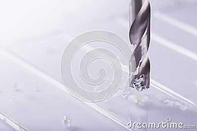 Drill bit make holes in opacity plastic, glass billet Stock Photo