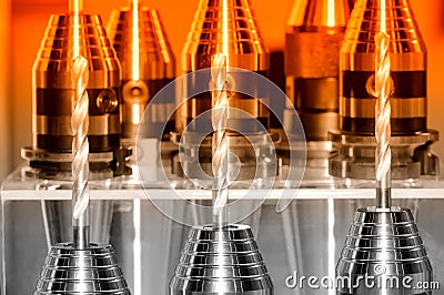 Drill chucks with drill bits on a stand. Red toned Stock Photo