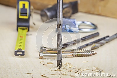 Drill drilling into the wood Stock Photo