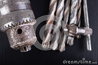 Drill and drills on a workbench. Tools for construction workers Stock Photo