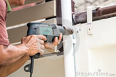 Drill the wall to install wall decoration Stock Photo