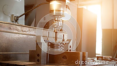 Drilling a hole with a drilling machine in a metal workpiece pulley, close-up, industry, manufacturing gin Stock Photo