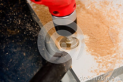 Drilling a hole for a hinge on a furniture door. Selective focus. Close up Stock Photo