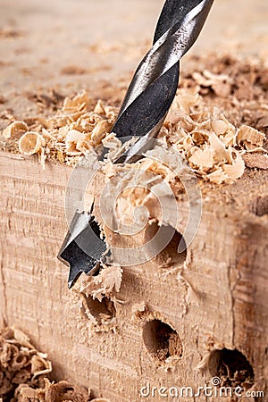 Drilling holes in raw wood. Carpentry drill in a carpentry workshop Stock Photo