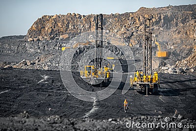 Drilling machine rigs borer wells for installing cast explosives blasting. Open mine coal and minerals from bowels soil Stock Photo