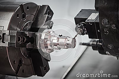 drilling operation on cnc lather machine. metal cutting and precision machining Stock Photo