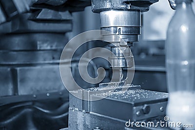 The drilling operation the metal plate part with NC milling machine Stock Photo