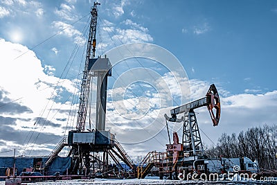 Drilling rig in oil field for drilled into subsurface in order to produced crude. Stock Photo