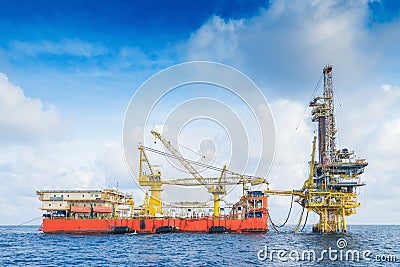 Drilling Rig working on production wellhead remote platform to completion on gases and crude oil well. Stock Photo