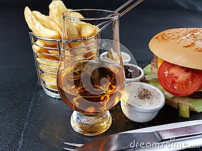 Drink alcohol bar beverage burger sauces blackplate blackbackground eat Stock Photo