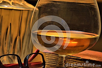 Drink cognac glass and old book Stock Photo