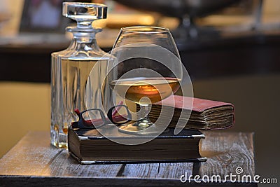 Drink cognac glass and old book Stock Photo
