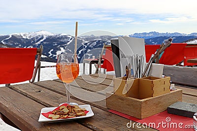 Drink and cookies on the table in the mountains. Menu and cutlery. Stock Photo