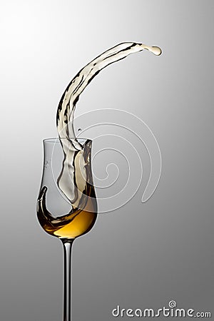 The drink spills out of the glass Stock Photo