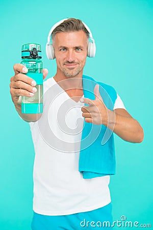 Drink water avoid thirst. Thirsty sportsman point at water bottle. Selective focus. Fit man advertise bottle to quench Stock Photo