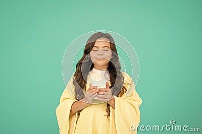 Drink well, live well. little girl drink cocoa or milk before sleeping. cosy and fluffy pajama. feeling comfortable at Stock Photo