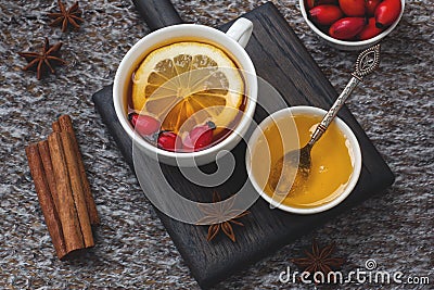 Drink from wild rose berries with lemon and honey cinnamon. Vitamin useful decoction of rose hips. cozy home concept of winter Stock Photo