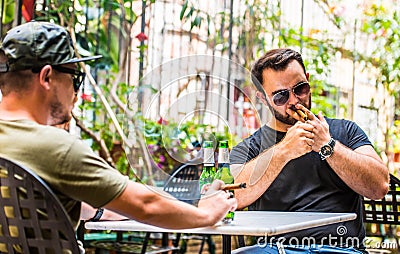 Drinking beers and smoking a cigar Stock Photo