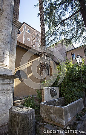 Drinking fountain with a lion head in a courtyard in Rome Stock Photo