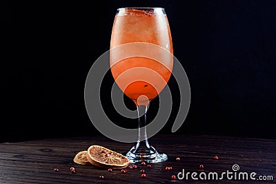 Drinks tropical citrus fruits over ice, with sprigs of herbs, grants space for text in blurred background Stock Photo