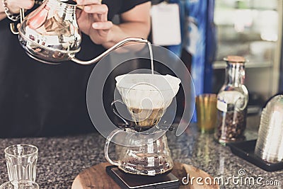 Drip coffee, barista pouring water on coffee ground with filter Stock Photo