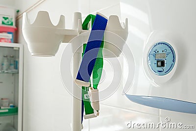 Drip stand and test harnesses. An ultraviolet lamp hangs on the wall. Treatment room Editorial Stock Photo