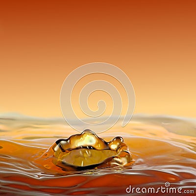 Dripping golden fluidity, a crown of water. Stock Photo