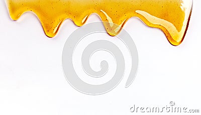 Dripping honey seamlessly repeatable from the top over white with copyspace and text Stock Photo