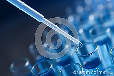 Dripping reagent into test tube with liquid sample on background, closeup. Laboratory analysis Stock Photo