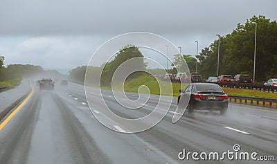 Drive car in rain on asphalt wet road. Cars the traffic light Editorial Stock Photo