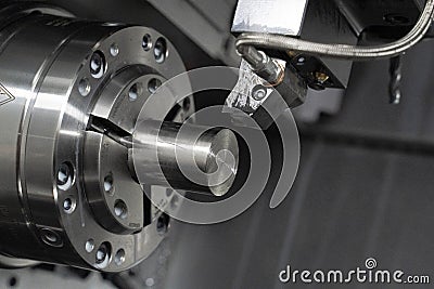 driven tool machining a piece in a cnc lathe Stock Photo