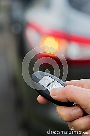 Close Up Of Driver Activating Car Security System With Key Fob Stock Photo