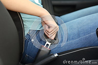 Driver hand fastening seatbelt in a car Stock Photo