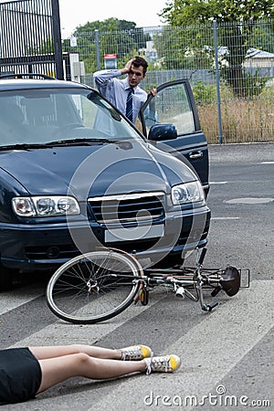 Driver hitting a female biker Stock Photo