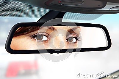 Driver looks to rear-view mirror Stock Photo