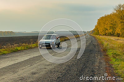 Driver of the private car saluting transport passing by on an autumnal road Editorial Stock Photo